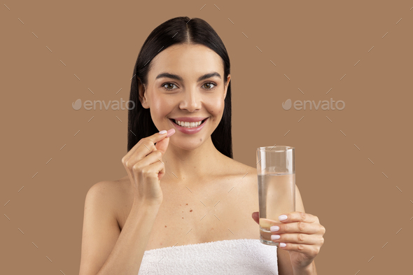 Happy Smiling Woman Taking Pill, Holding Glass Of Fresh Water