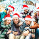 Trendy friends group wearing santa hat using mobile phone on winter Christmas holiday - PhotoDune Item for Sale