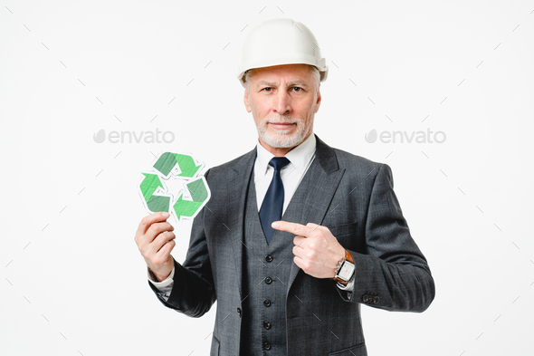 Caucasian elderly senior engineer architect pointing at recycling logo sign for zero waste lifestyle