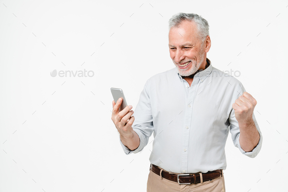 Caucasian happy grandfather using cellphone for lottery, online casino bets, cashback, sale discount