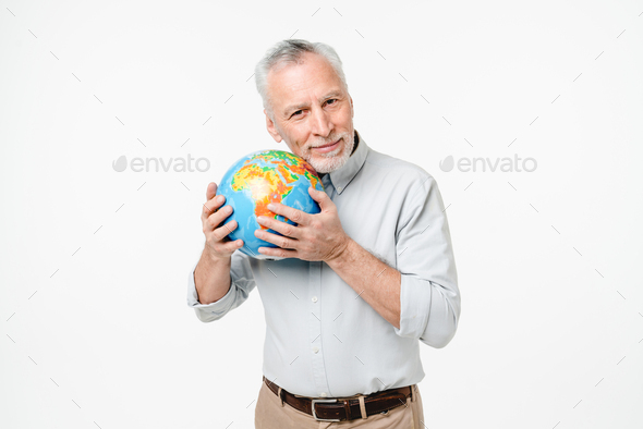 Traveling geography teacher. Caucasian mature man holding hugging embracing protecting globe Earth