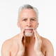 Caucasian shirtless naked elderly man going to shave beard, touching face, applying aftershave balm - PhotoDune Item for Sale