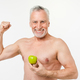 Strong powerful mature elderly senior shirtless naked man holding green apple with toothy smile - PhotoDune Item for Sale