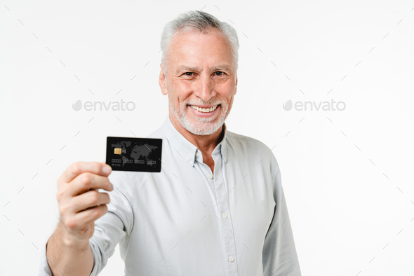 Mature caucasian senior businessman grandfather customer client holding credit card  - Stock Photo - Images
