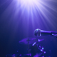 Illuminated microphone against drum kit on stage - PhotoDune Item for Sale