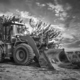 A bulldozer or loader moves the earth at the construction site against the sky - PhotoDune Item for Sale