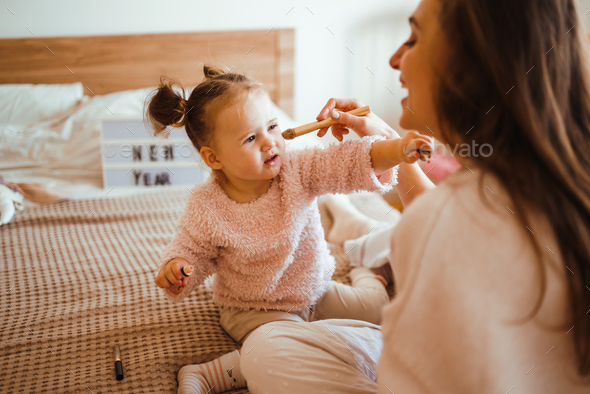 Little Girl Doing Makeup To Mom Mother