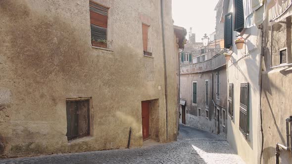 Historical Bracciano town view of a small car going through a traditional narrow street, Italy alt