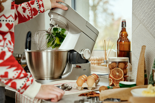 Woman cooking at home kitchen, use electric mixer to preparing dough - Stock Photo - Images