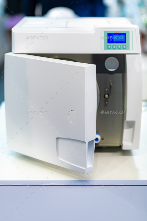 Sterilization desk with autoclave in a dental clinic. Stock Photo by microgen
