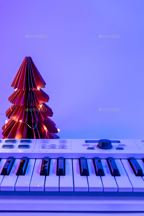 Christmas background with midi keyboard and holiday decor with neon