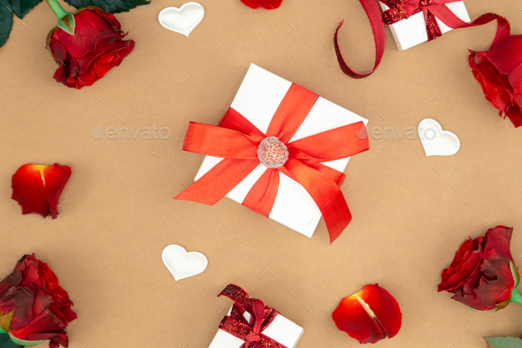 Gift box, red roses and decorative details, flat lay. - Stock Photo - Images