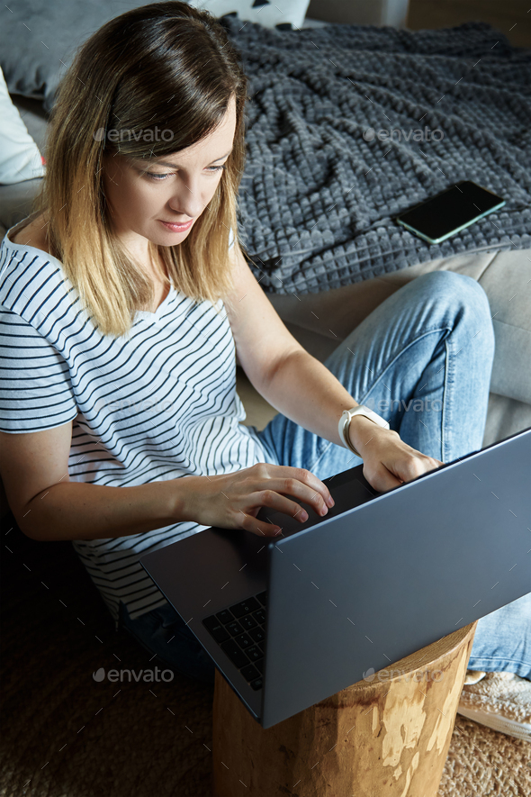 Woman at home using laptop. Remote work at home office - Stock Photo - Images
