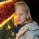 Blond girl leaning on Christmas tree with garlands - PhotoDune Item for Sale
