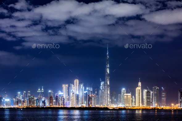 Skyscrapers skyline of Dubai UAE downtown with Burj Khalifa at night - Stock Photo - Images