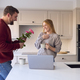 Romantic Couple In New Home With Man Giving Woman Bunch Of Flowers - PhotoDune Item for Sale