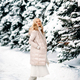 Fashion young smiling blonde woman in winter. Standing among snowy trees in winter forest. - PhotoDune Item for Sale