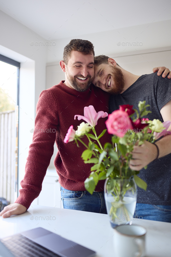 Loving Same Sex Male Couple Hugging In Kitchen Of New Home - Stock Photo - Images
