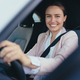 Excited young woman sitting in her car, prepared for driving. - PhotoDune Item for Sale