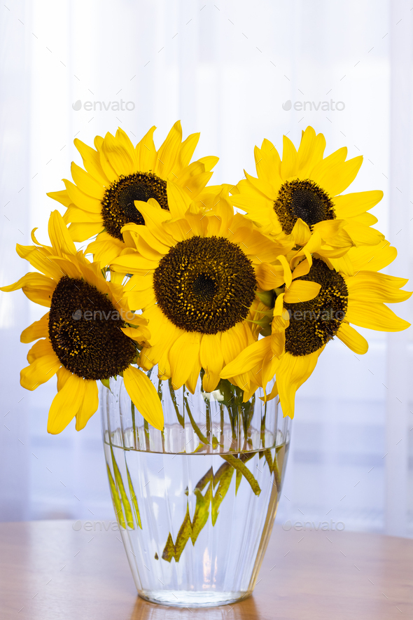 Autumn. Yellow sunflowers in a vase are on the table. Postcard with copy space.