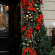 Stylish christmas fir branches with baubles and poinsettia on building exterior - PhotoDune Item for Sale