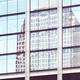 Building reflected in windows of a modern skyscraper, abstract urban background, New York City, USA. - PhotoDune Item for Sale