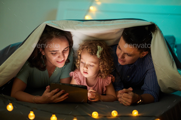 Mothers Reading E-book to daughter - Stock Photo - Images
