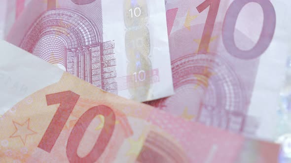 Paper Euro banknotes on white background slow tilting 4K 2160p 30fps UltraHD footage - Slow tilt ove alt