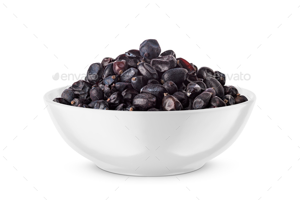 Black dried barberry in white bowl isolated on white. Front view. - Stock Photo - Images