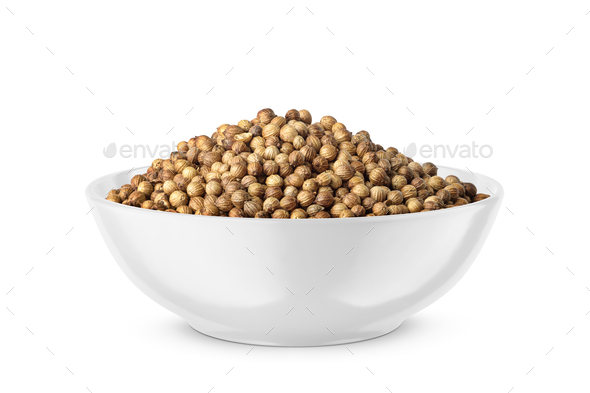 Dry coriander seeds in round bowl isolated on white. Side view. - Stock Photo - Images