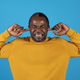 African american mature man plugging ears with fingers - PhotoDune Item for Sale