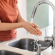 Closeup Shot Of Young Woman Washing Hands In Kitchen Sink - PhotoDune Item for Sale