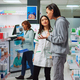 Asian worker explaining pharmacy leaflet in medical retail store - PhotoDune Item for Sale