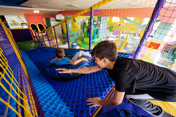 Kids playing at indoor play center playground in tubes. - Stock Photo - Images