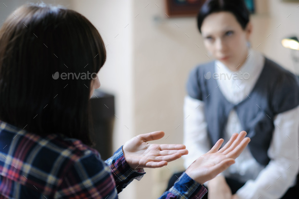 Desperate gestures - young woman at a counselling session with a therapist - Stock Photo - Images