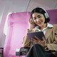 Young caucasian smiling female enjoying her comfortable flight while sitting in airplane cabin - PhotoDune Item for Sale