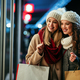 Christmas shopping people concept. Happy young women with shopping bags buying presents - PhotoDune Item for Sale