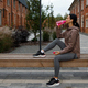 Sports woman in earphones drinking water after jogging on the bench - PhotoDune Item for Sale