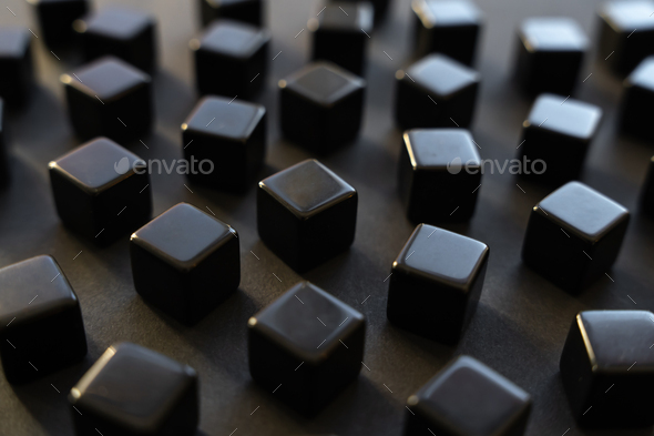Black blocks on a dark background. Scattered cubes.