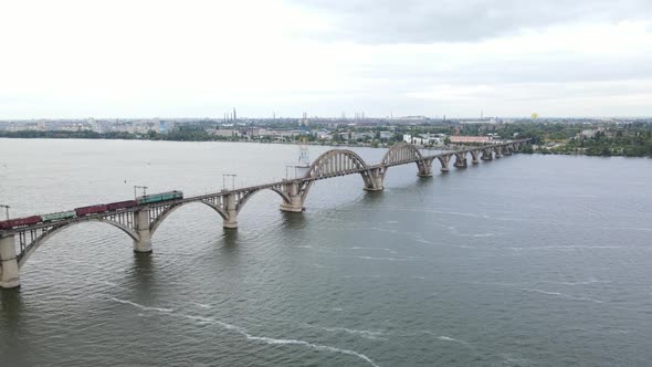Aerial View of a Train Crossing a Beautiful Bridge