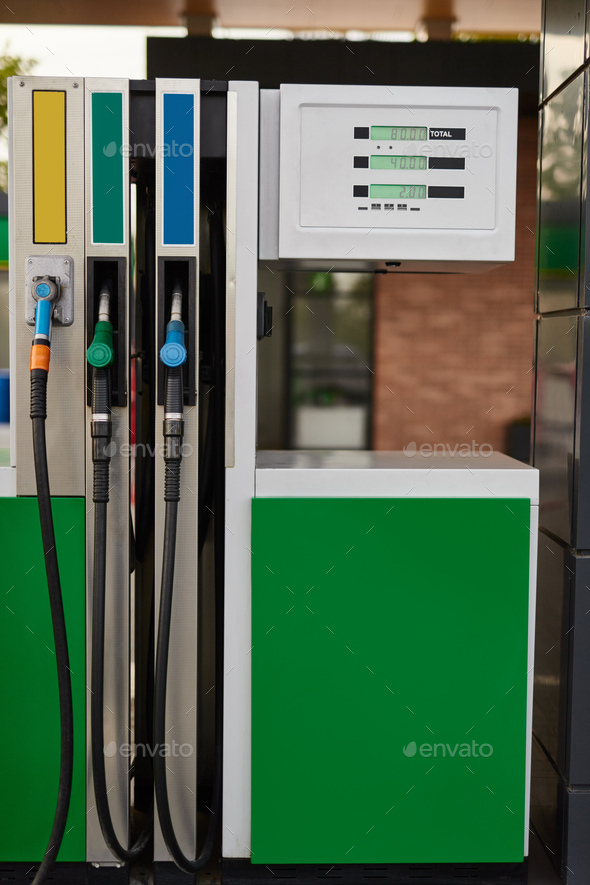 Modern fuel dispenser at gas station in daytime