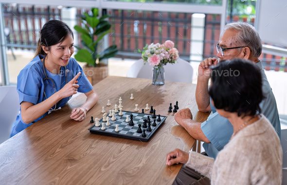 Caregiver Take Care Senior Retirement Person Sitting Play Chess 