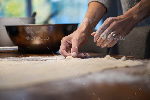 Low angle view of a woman preparing homemade pastry dough for a strudel or pie - Stock Photo - Images