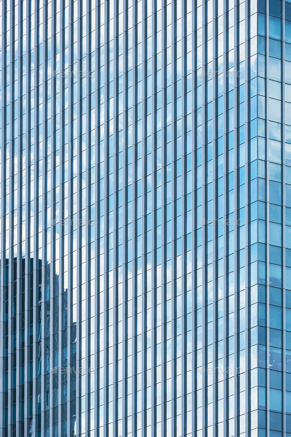 Sky reflection on glass wall surface of skyscraper in perspective view ...