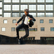 Young entrepreneur jumping and dancing to celebrate his successful day - PhotoDune Item for Sale