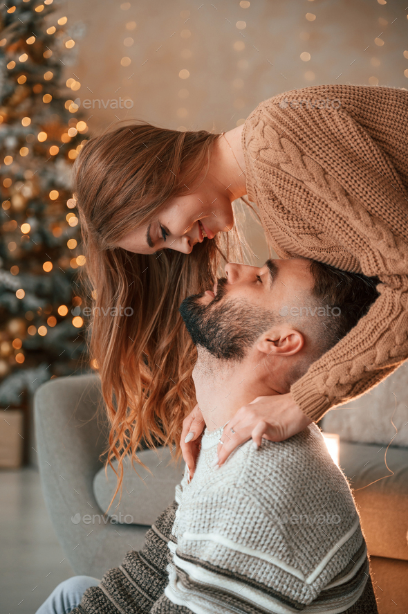 Lovely young couple are celebrating New Year at home - Stock Photo - Images