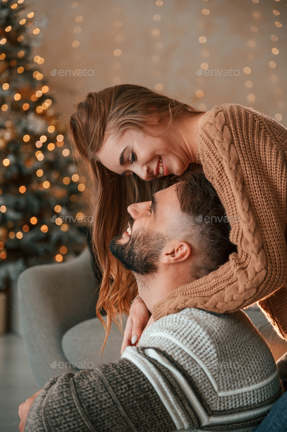 Lovely young couple are celebrating New Year at home - Stock Photo - Images