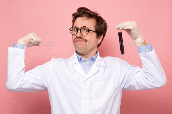 Scientist hlding a glass tube with blue fluid being happy he made a great discover.