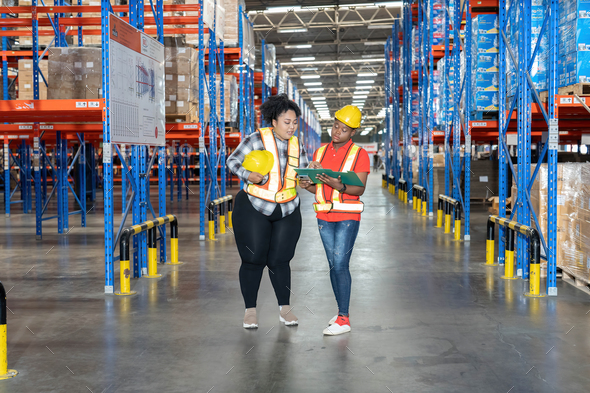 Diverse worker in warehouse hold check sheet looking storage scan location to keep and collect boxes