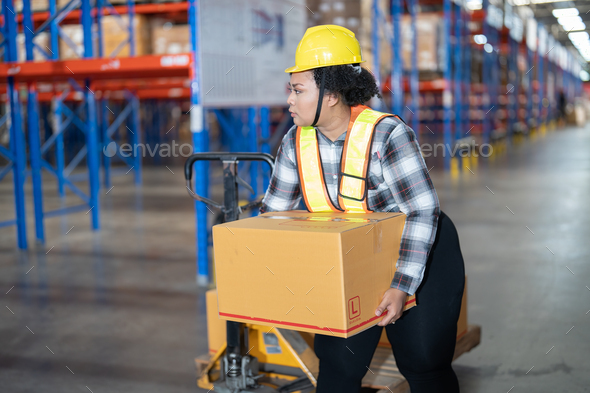 Overweight fat woman in warehouse pull hand pallet truck lift box to place in storage location